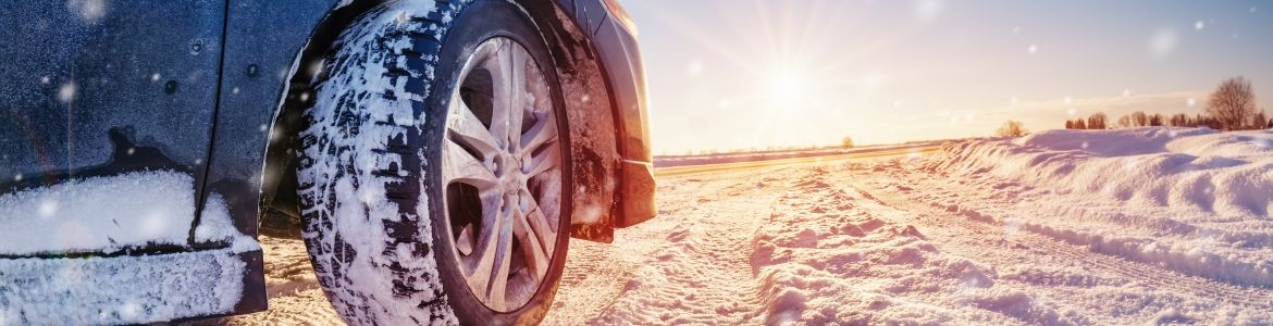 close view of car wheel on snowy road 