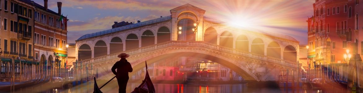 Man in a gondola near the Rialto Bridge in Venice, Italy