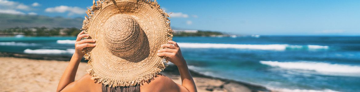 woman with hat on majorca beach