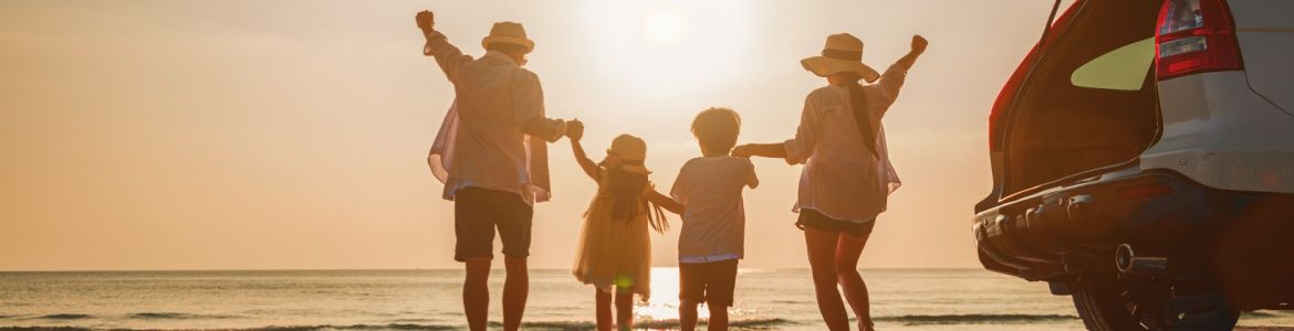 Happy family travelling by car to the beach